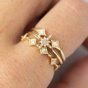 Gold double star open ring with natural white diamonds worn on finger, featuring brilliant cut stones and delicate design