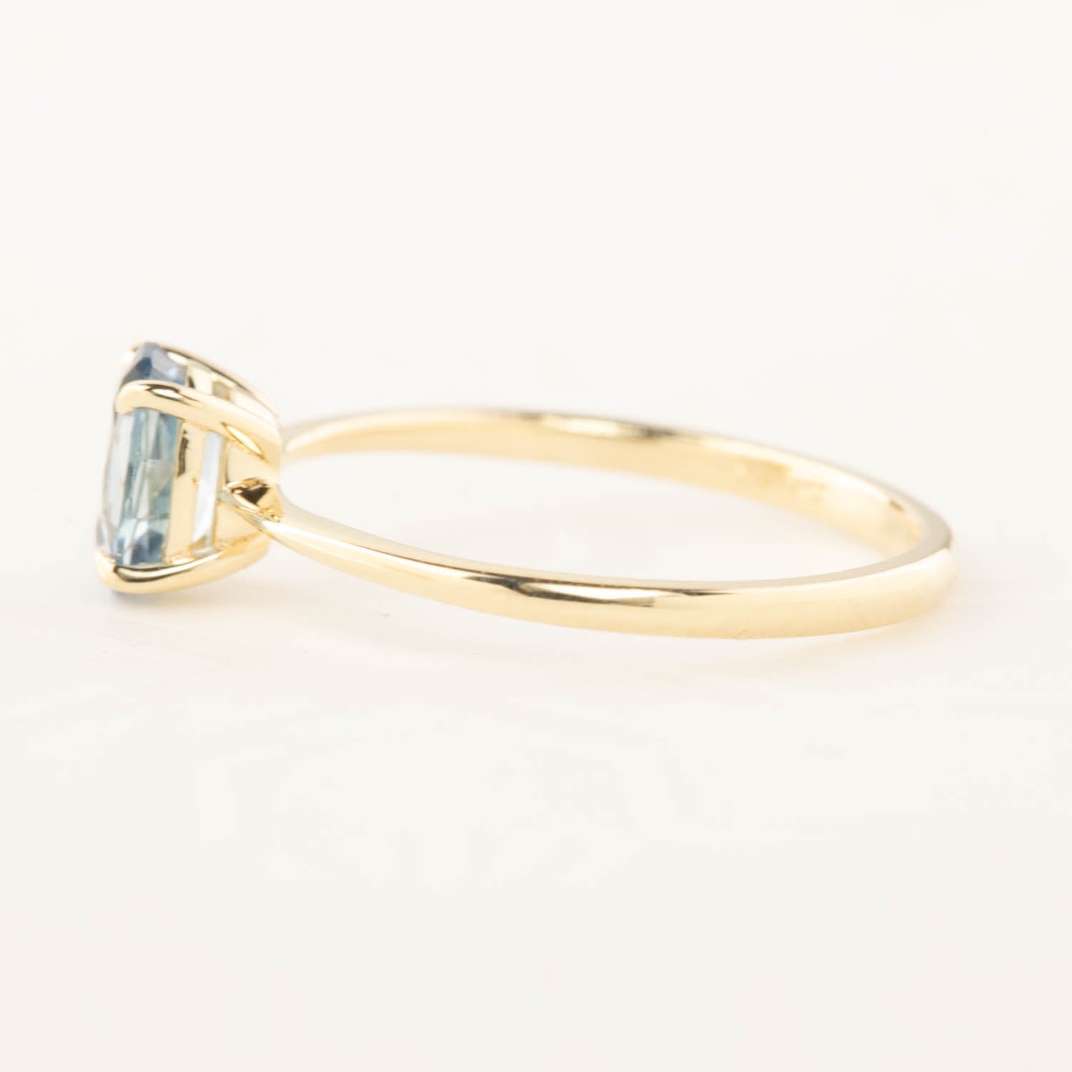 Side view of Nina Ring with 0.98ct blue Montana sapphire set in recycled 14k rose gold tapered band