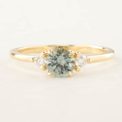 Emilie Ring with 0.66ct light blue-green Montana sapphire and two small diamonds in 14k recycled gold band
