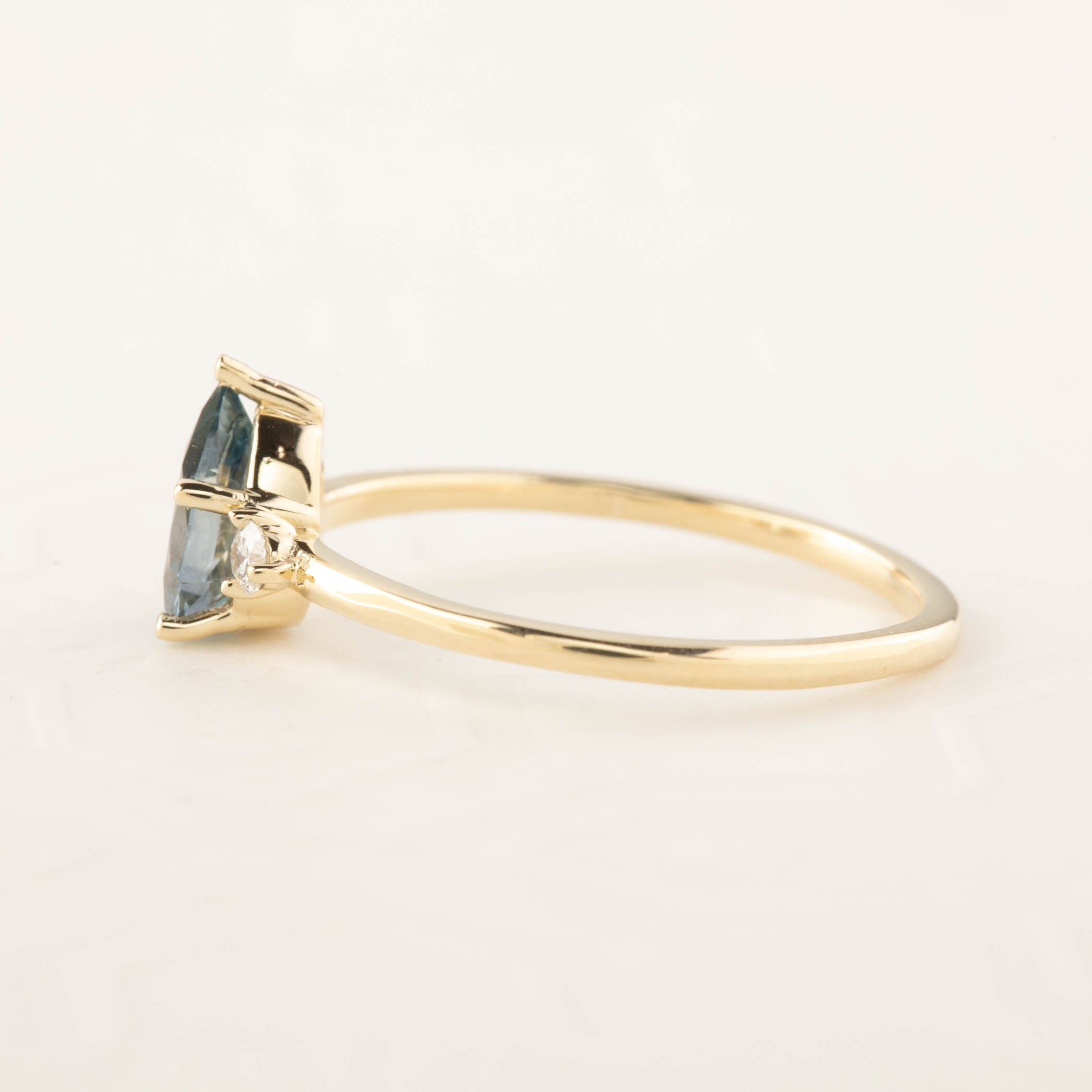 Emilie Ring featuring a 0.84ct pear cut Blue Montana Sapphire in recycled 14k yellow gold, handmade and one of a kind.
