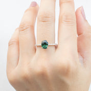 Maria Ring 1.65ct Peacock Green Sri Lankan Oval Sapphire in 14k yellow gold with natural diamond accents on hand.