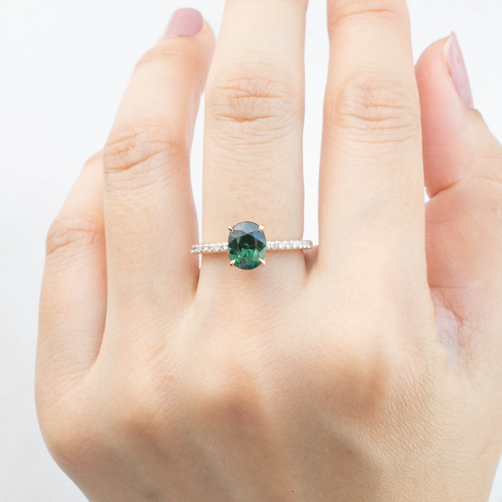 Maria Ring 1.65ct Peacock Green Sri Lankan Oval Sapphire in 14k yellow gold with natural diamond accents on hand.