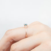 Emilie Ring featuring 0.66ct blue-green Montana sapphire set in 14k rose gold with diamond accents, handmade and unique.