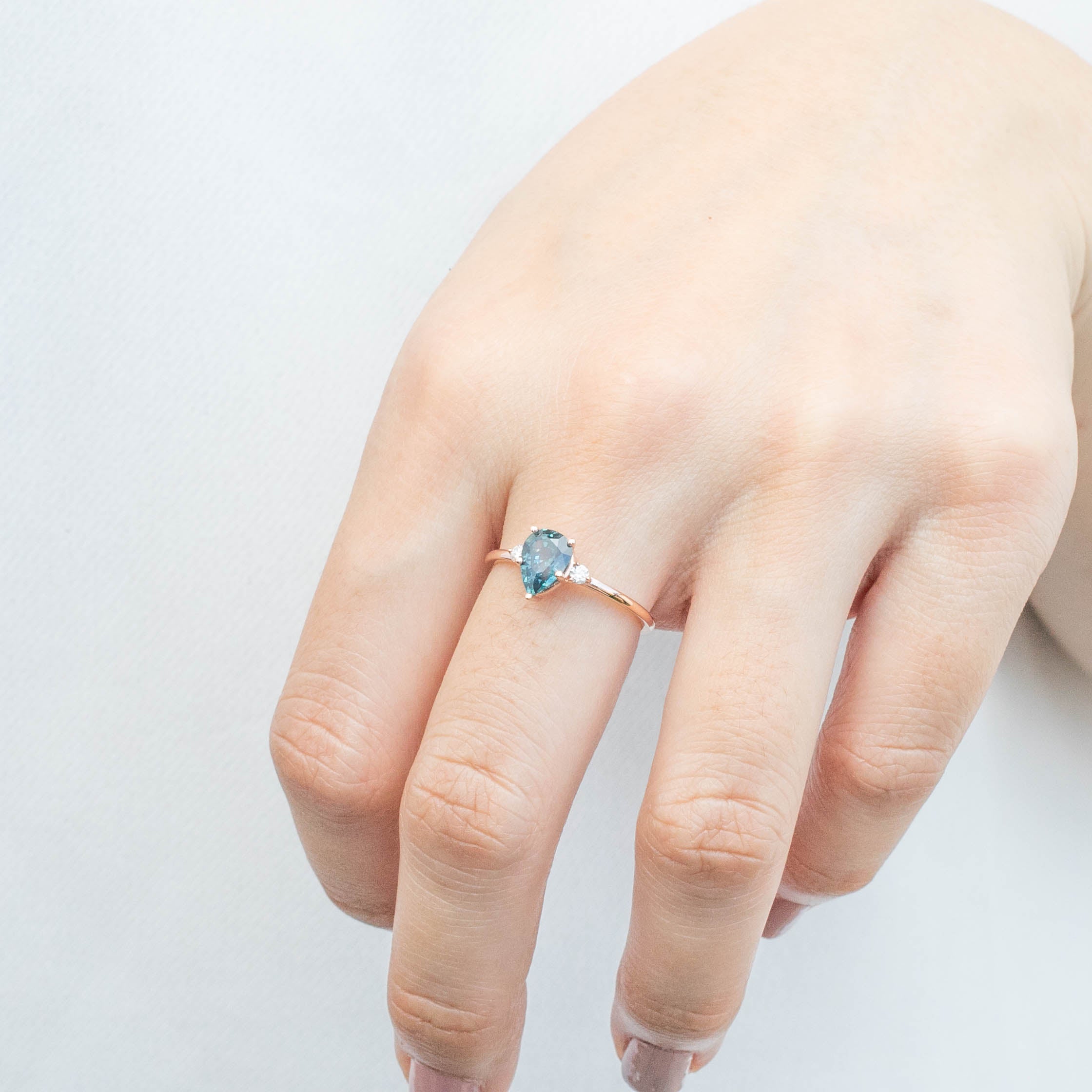 Emilie Ring featuring 1.07ct pear cut blue-green Montana sapphire set in recycled 14k rose gold band