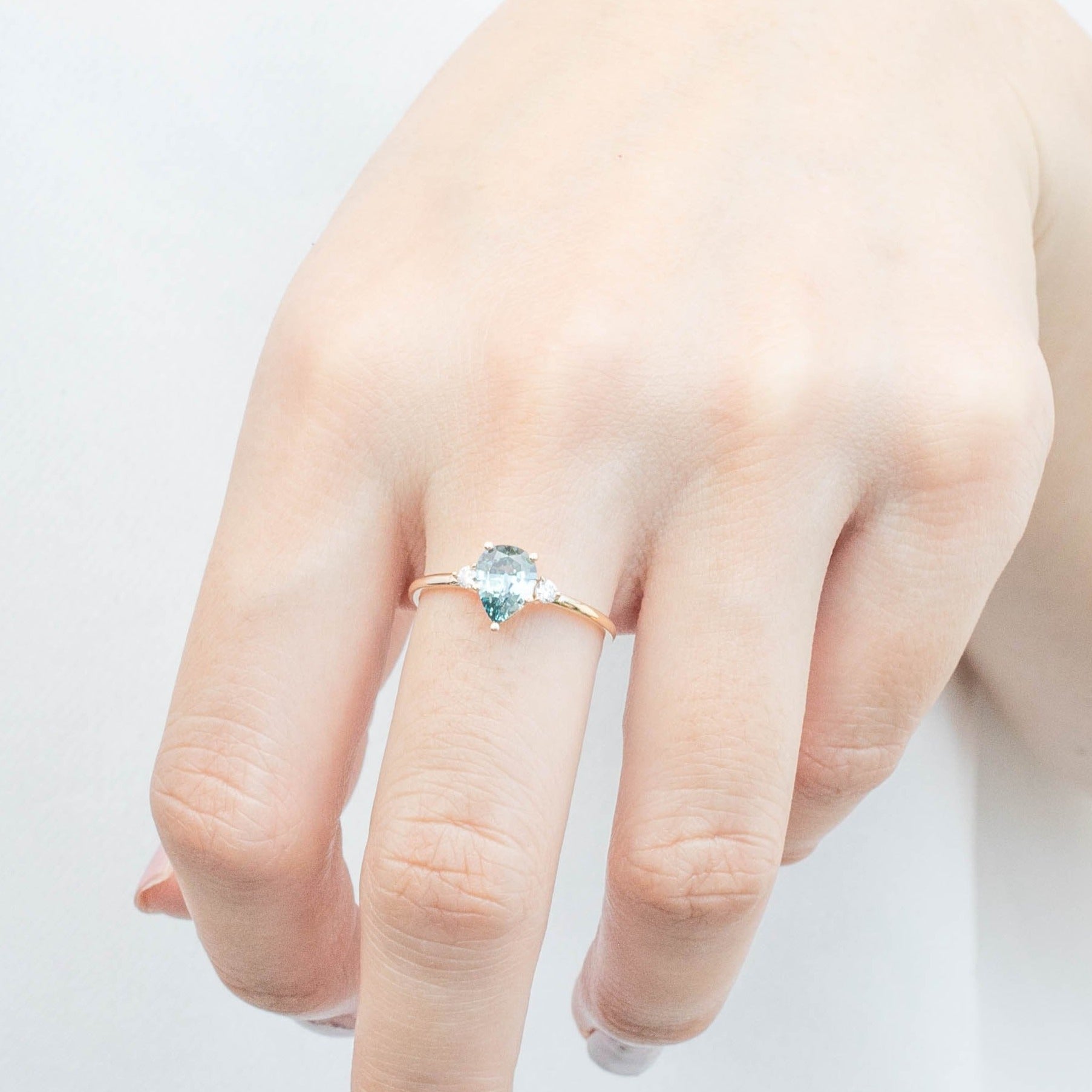 Emilie Ring featuring a 0.84ct pear cut blue Montana sapphire in 14k recycled yellow gold, handmade and one of a kind.