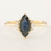 Lena Ring with 0.94ct marquise dark blue green sapphire and white accent diamonds in recycled 14k gold