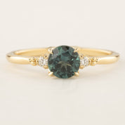 Estel Ring featuring a 0.94ct peacock green Queensland sapphire with white diamond accents in 14k gold band