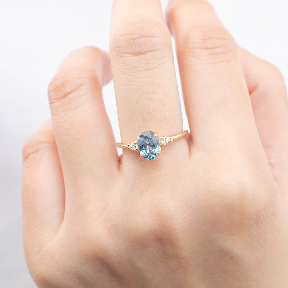 Estel Ring with 1.4ct light blue-green Montana sapphire, handmade and ethically sourced in 14k yellow gold band.