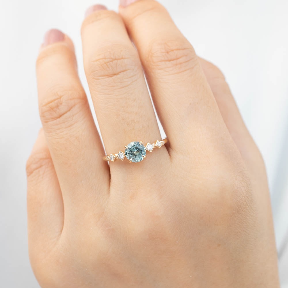 Celeste Ring with 1.1ct light green Montana sapphire and diamond accents in recycled 14k yellow gold band.