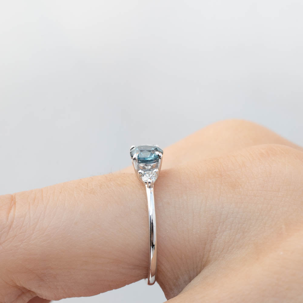 Emilie Ring with 0.85ct Blue Montana Sapphire, handmade one of a kind, ethically sourced white gold band on finger