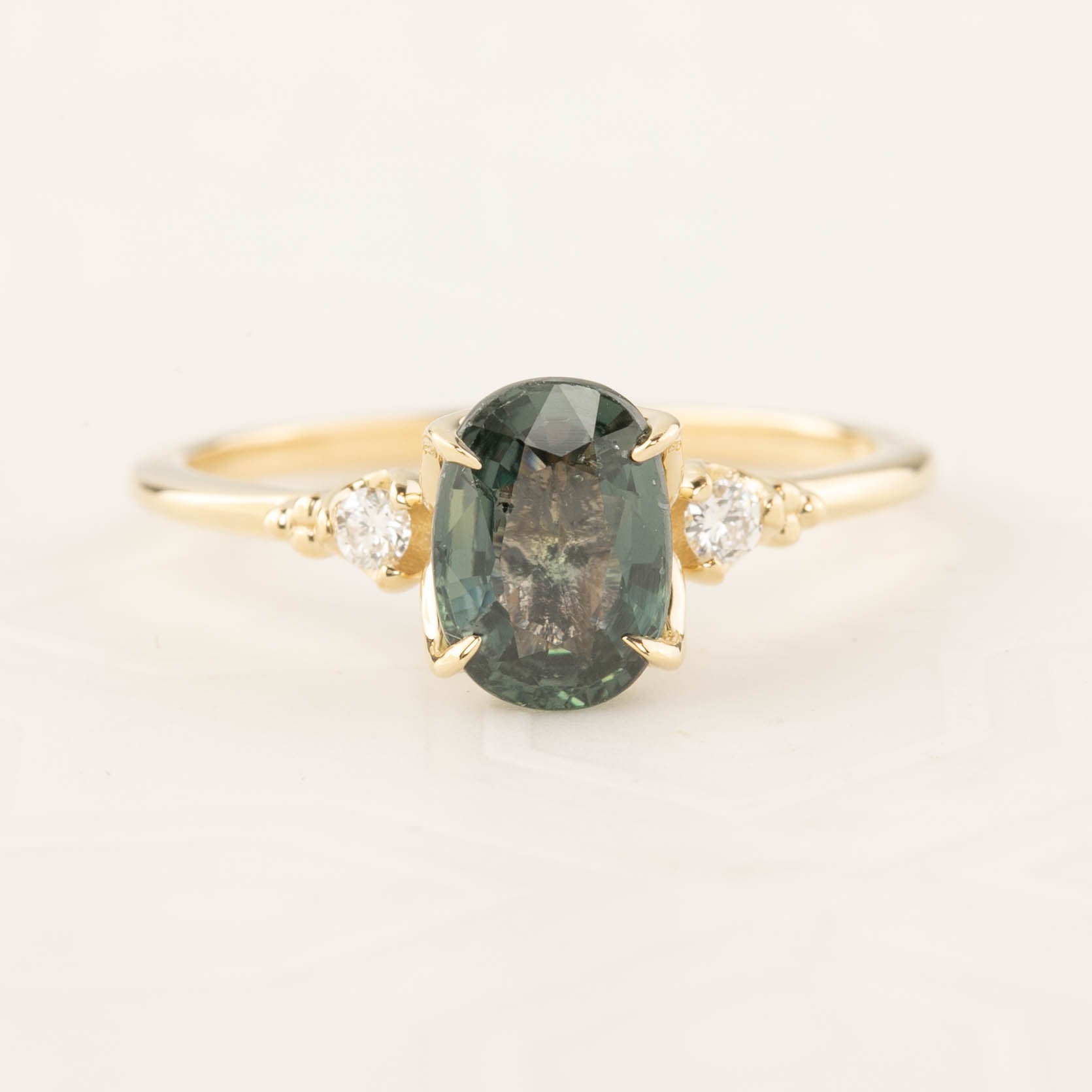 Estel Ring with 1.72ct peacock green sapphire in recycled 14k gold, accented with white diamonds, one of a kind design.