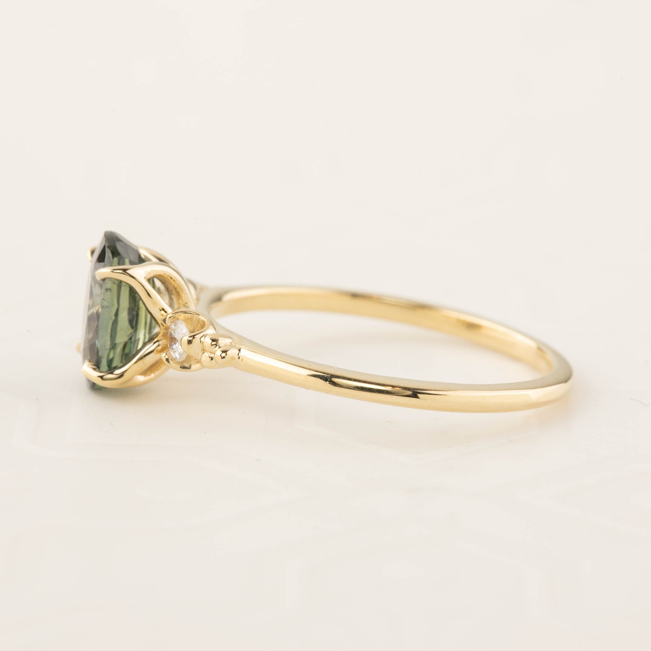 Estel Ring featuring a 1.72ct peacock green sapphire in a handmade recycled 14k gold setting with diamond accents.