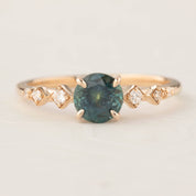 Celeste Ring featuring a 1.19ct teal blue Montana sapphire with accent diamonds in 14k rose gold, handmade and authentic.