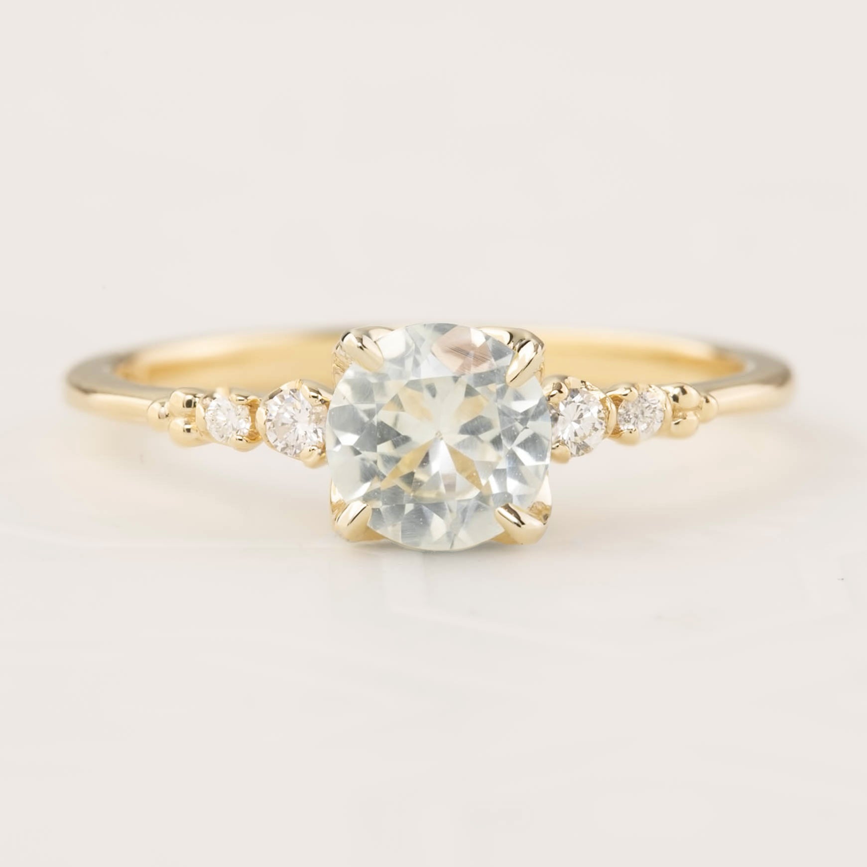 Estel Fleur Four Prongs Ring with 0.90ct white Montana sapphire, handmade in recycled 14k gold with diamonds.