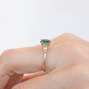Estel Ring featuring a 1.93ct green sapphire in a handmade recycled 14k gold setting with white accent diamonds