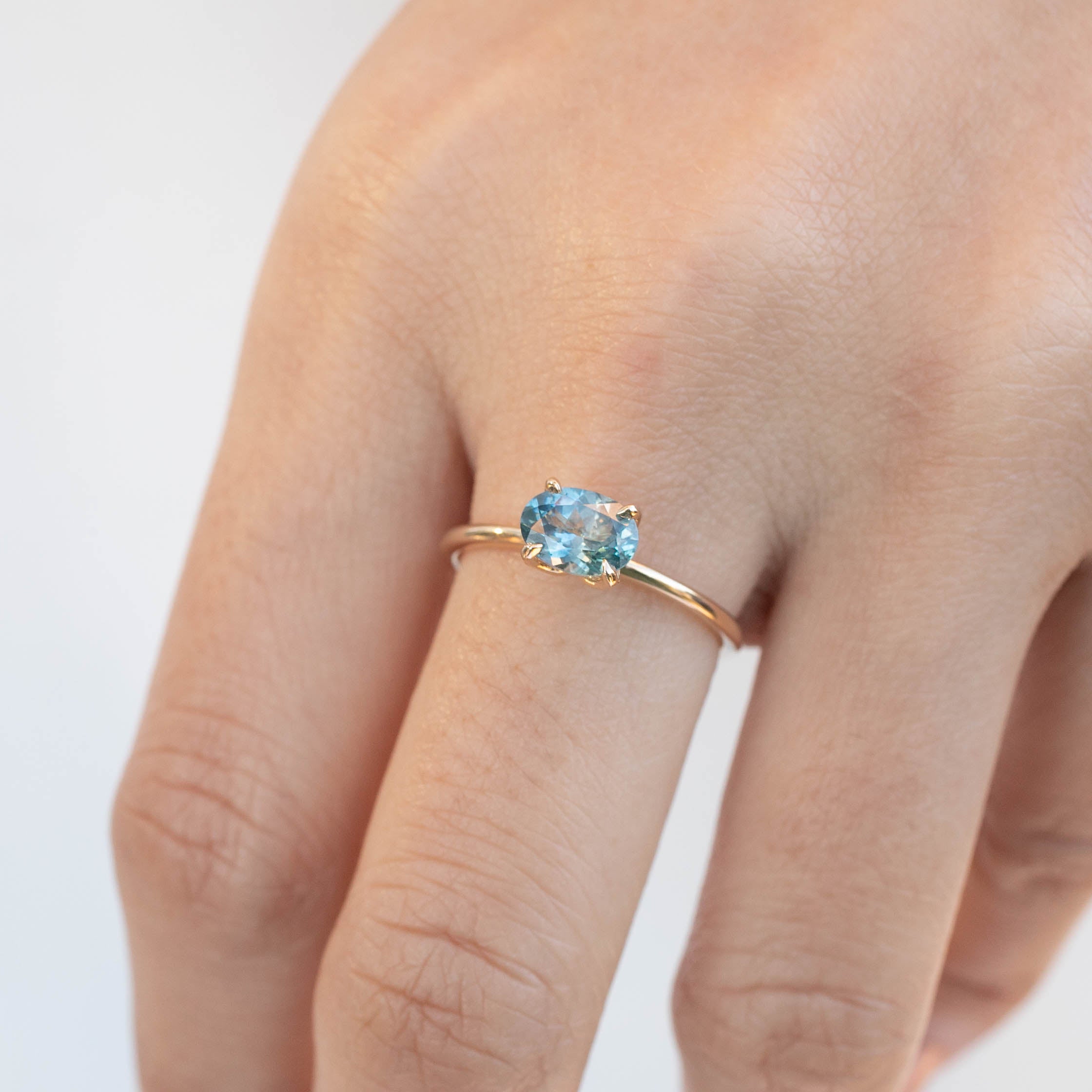 Sara Ring with 1.05ct blue green Montana Sapphire, handmade, ethically sourced, set in 14k recycled yellow gold band.