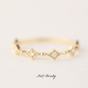 Gold eternity ring with natural white diamonds in star-shaped settings, delicate and ethically sourced design