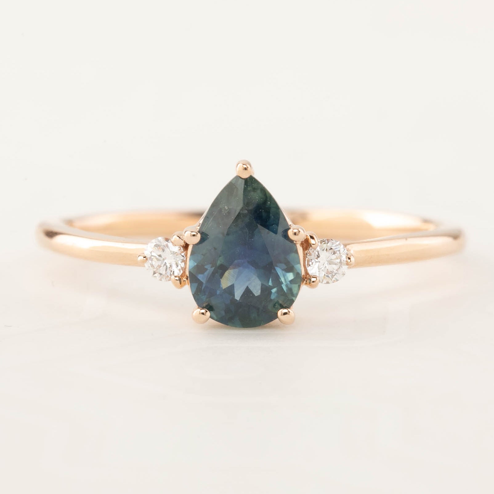 Emilie Ring with 0.90ct pear teal Montana sapphire and diamonds in handmade 14k rose gold setting