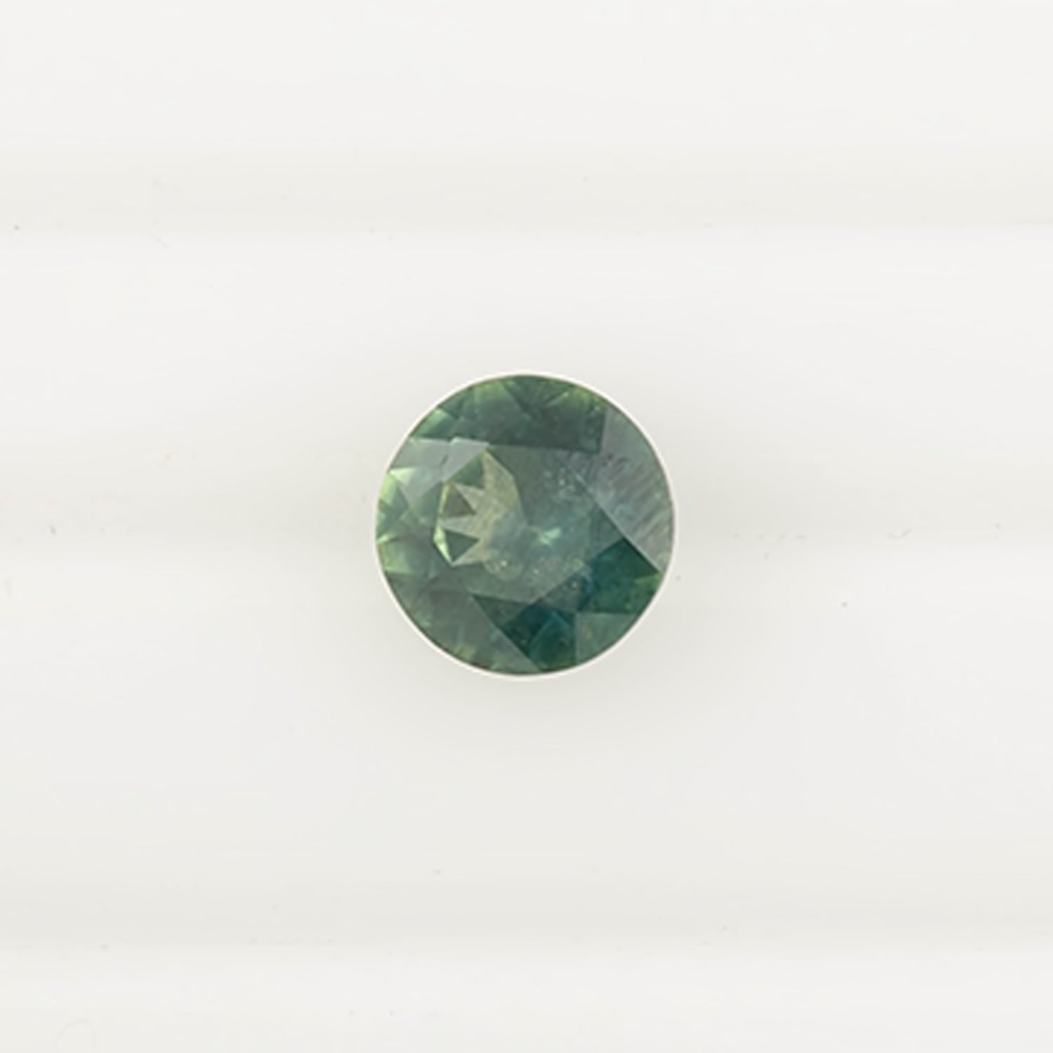 1.58ct round cut green Montana sapphire with a slight blue hint, ethically sourced and authentic stone