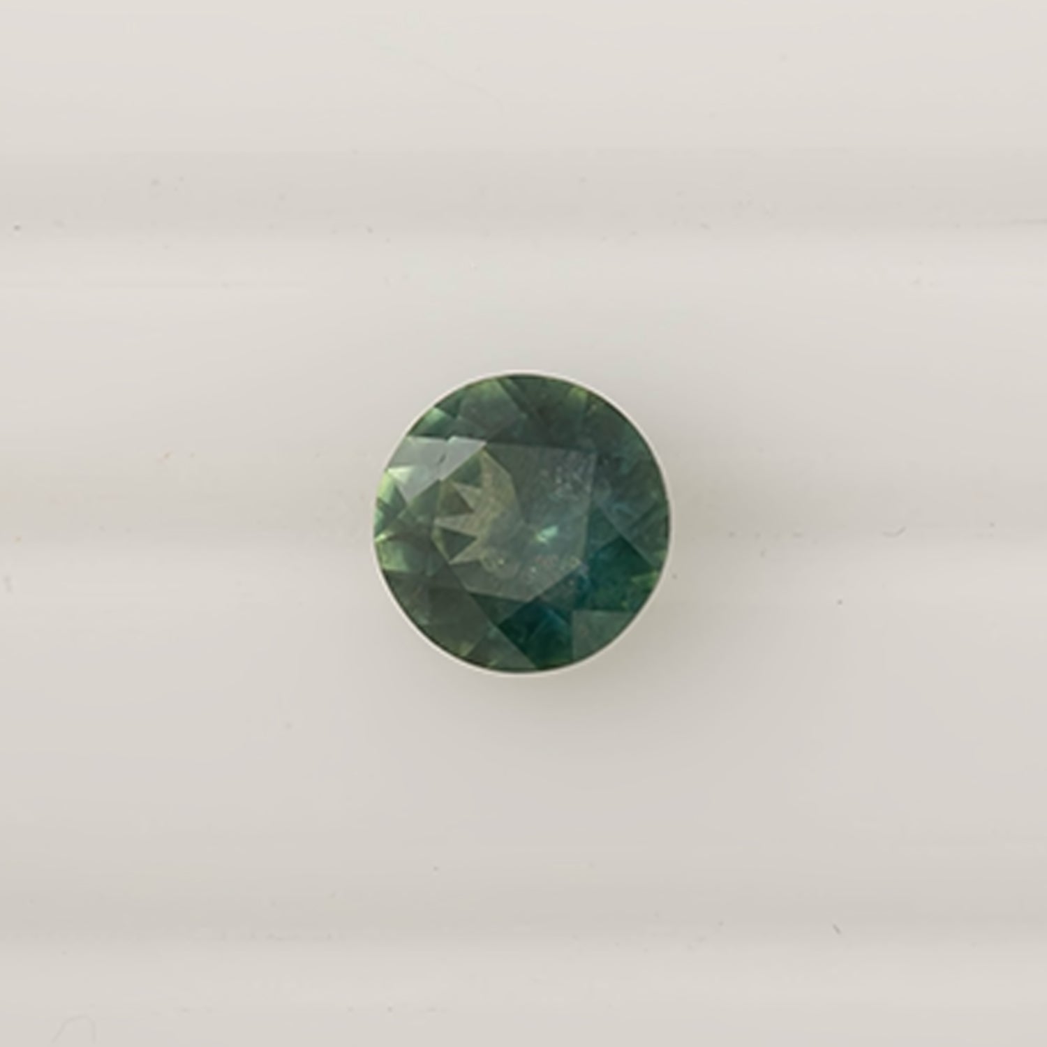 1.58ct round cut green Montana sapphire with slight blue tint, ethically sourced and authentic gemstone from Montana, USA.
