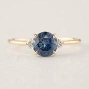 Emilie Ring featuring 1.52ct blue Montana sapphire with white diamonds set in recycled 14k yellow gold, handmade and one of a kind