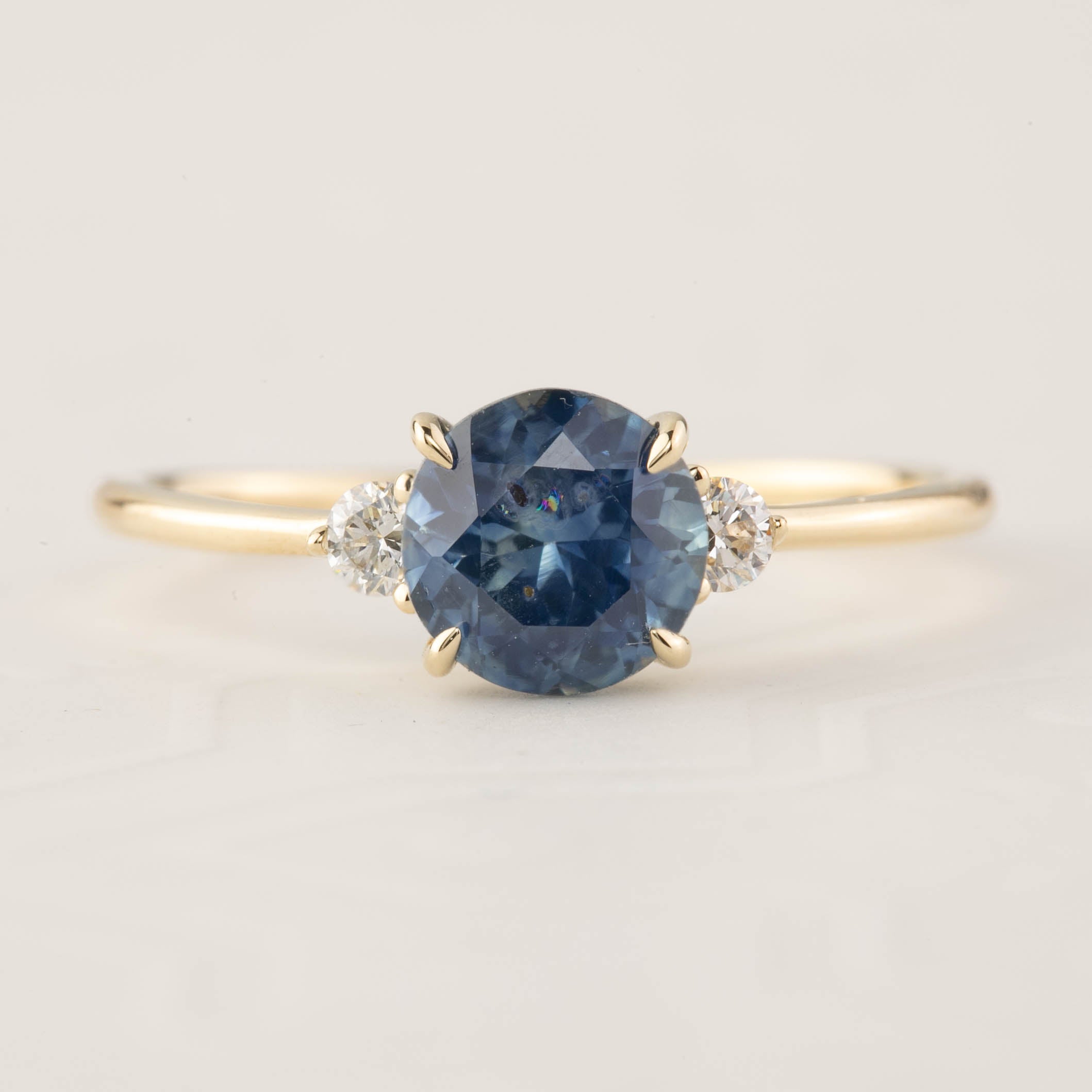 Emilie Ring featuring 1.52ct blue Montana sapphire with white diamonds set in recycled 14k yellow gold, handmade and one of a kind