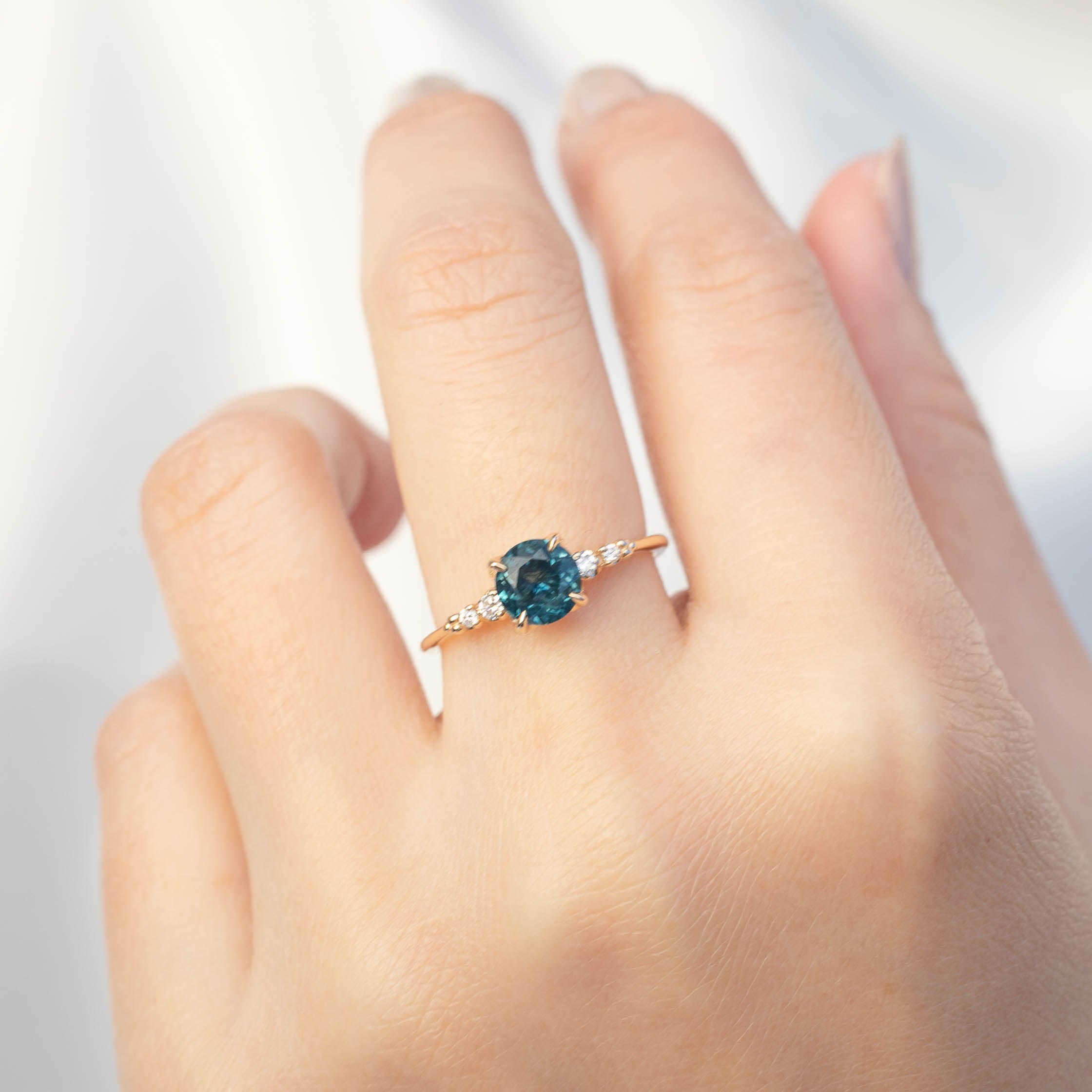 Estel Luxe Ring with 1.16ct blue green Montana sapphire and diamond accents in recycled 14k gold band