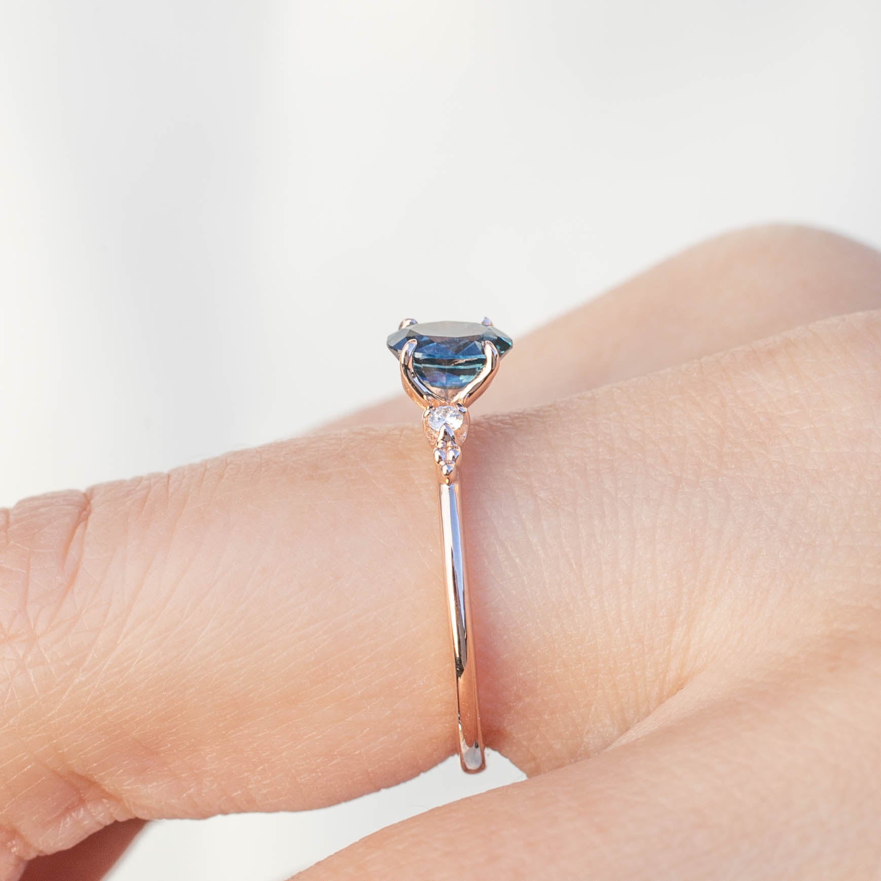Estel Ring with 0.83ct teal blue sapphire and white diamonds in handmade 14k rose gold, one of a kind design