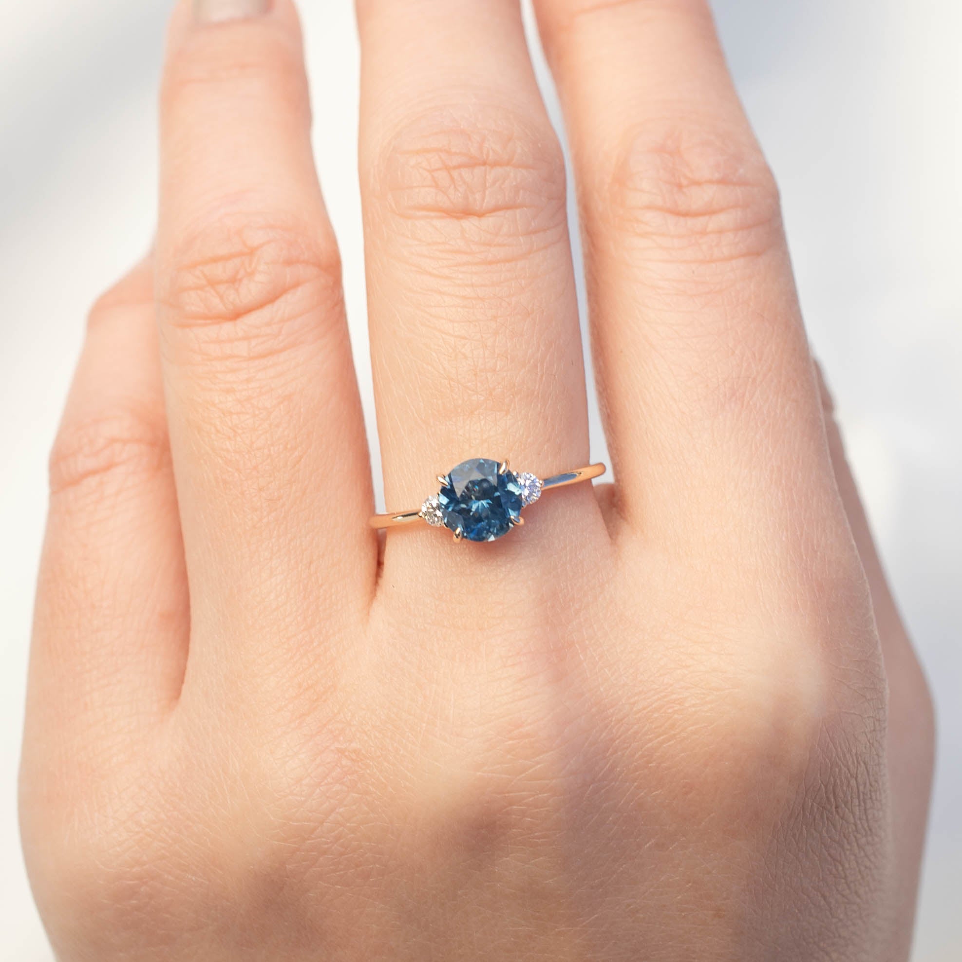Emilie Ring with 1.52ct Blue Montana Sapphire and white diamonds in recycled 14k yellow gold, handmade and one of a kind.