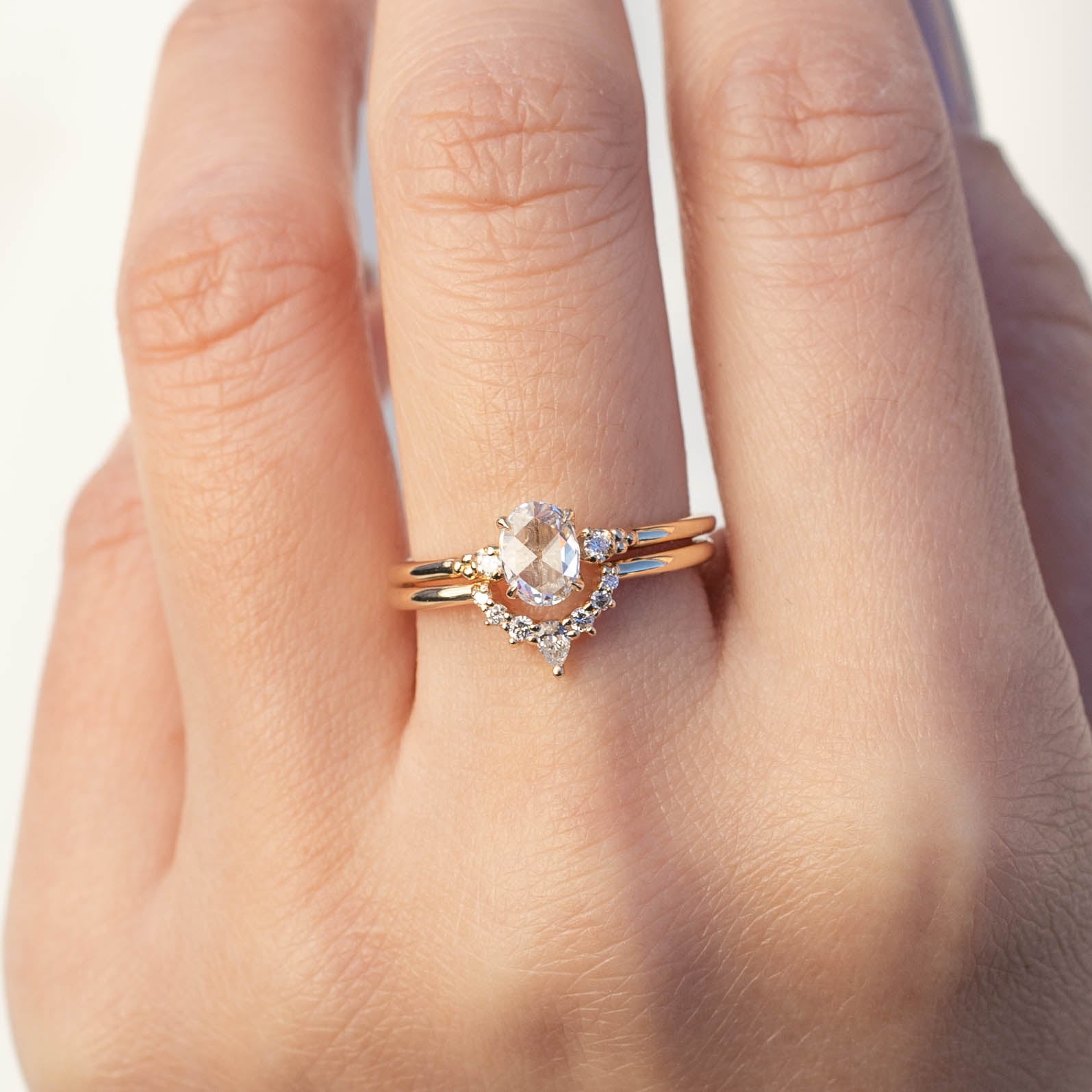 Bella's Crown Ring featuring natural white diamonds set in an ethically sourced gold band on a hand.