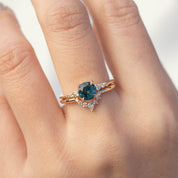 Bella's Crown Ring with a deep blue center stone and surrounding diamonds on a delicate gold band, ethically sourced design