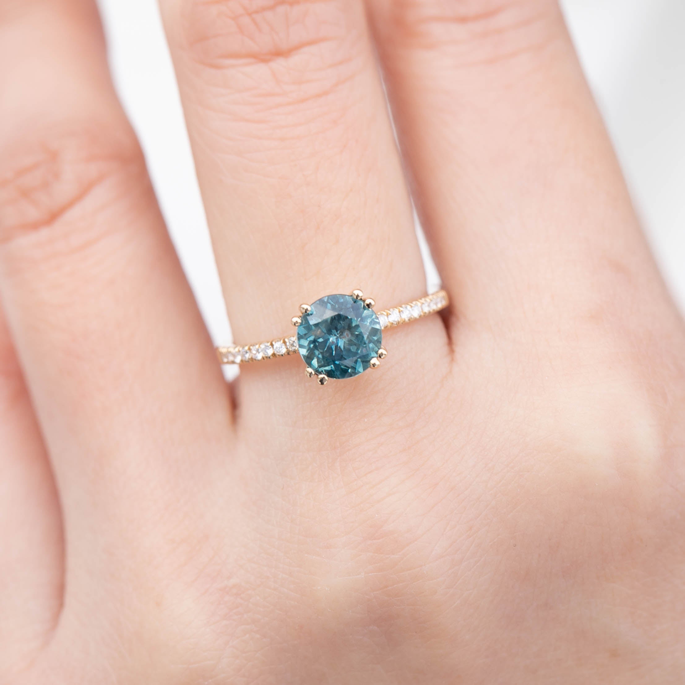Sabrina Ring featuring a 1.79ct teal blue sapphire in recycled 14k gold with white diamond accents, handmade one of a kind