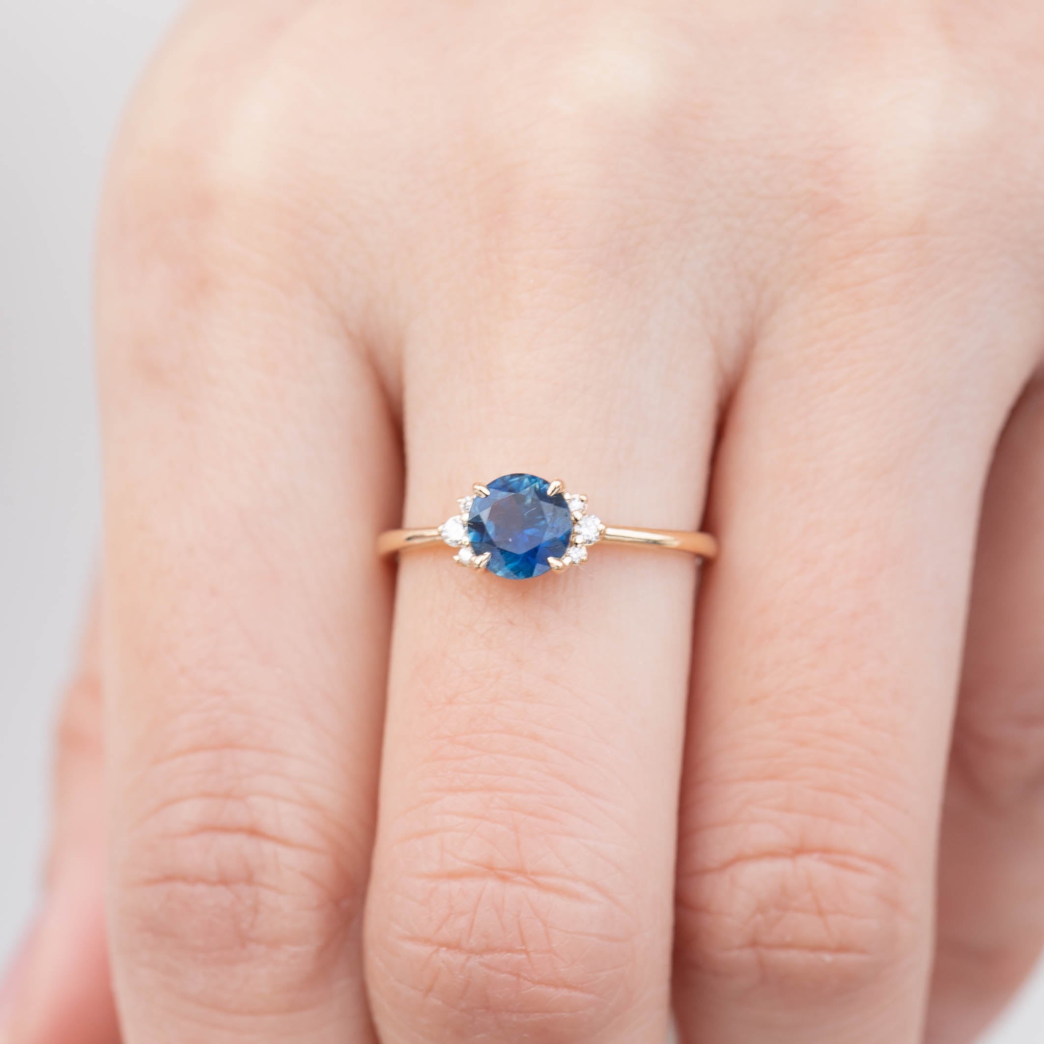 Stunning one-of-a-kind Lena Ring featuring a 1.18ct blue Montana sapphire and sparkling white diamonds in 14k yellow gold.