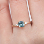 Estel Ring featuring a 1.07ct cushion cut light blue green Montana sapphire with diamond accents on recycled gold band