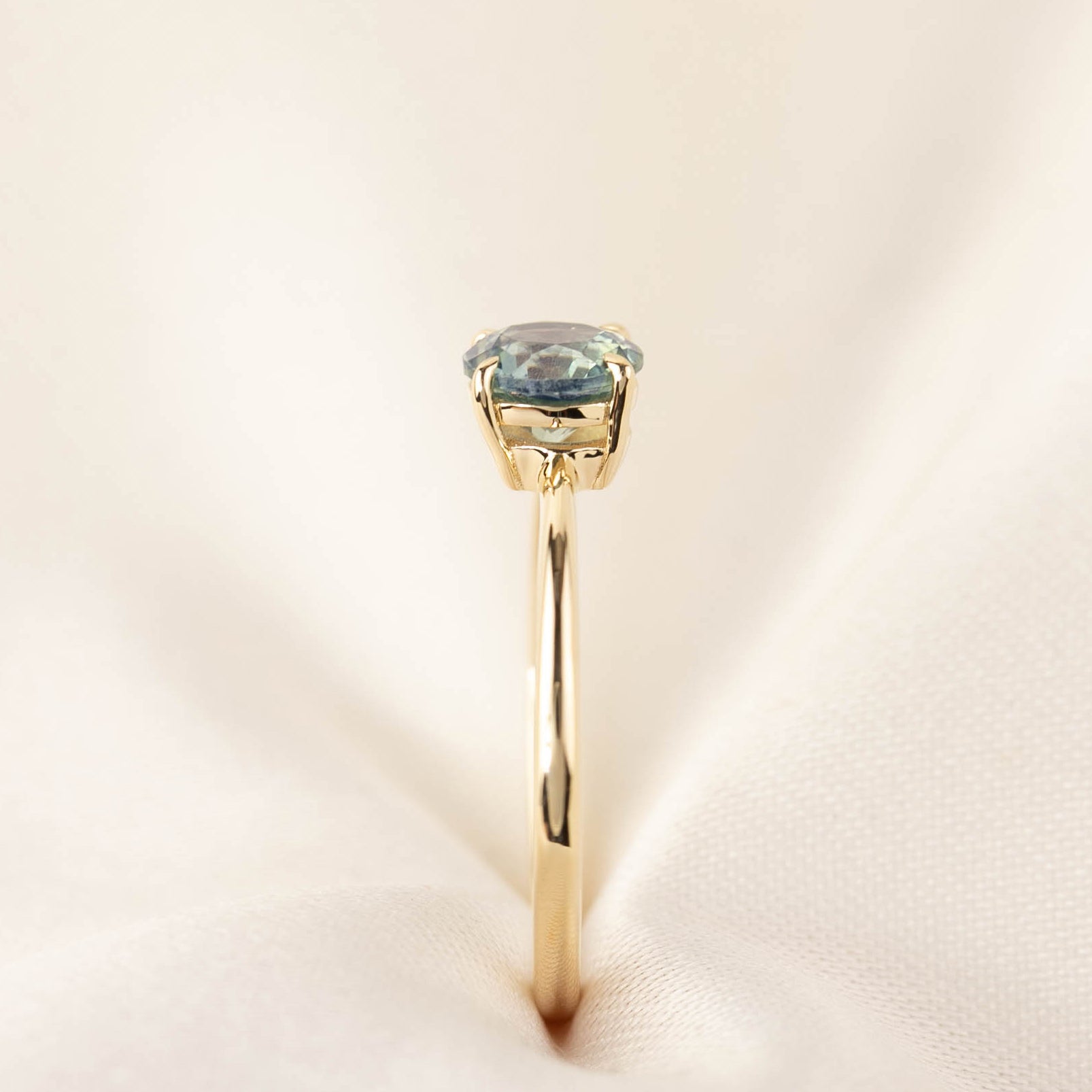Side view of Nina Ring featuring 0.94ct light blue Montana Sapphire set in 14k yellow gold tapered band