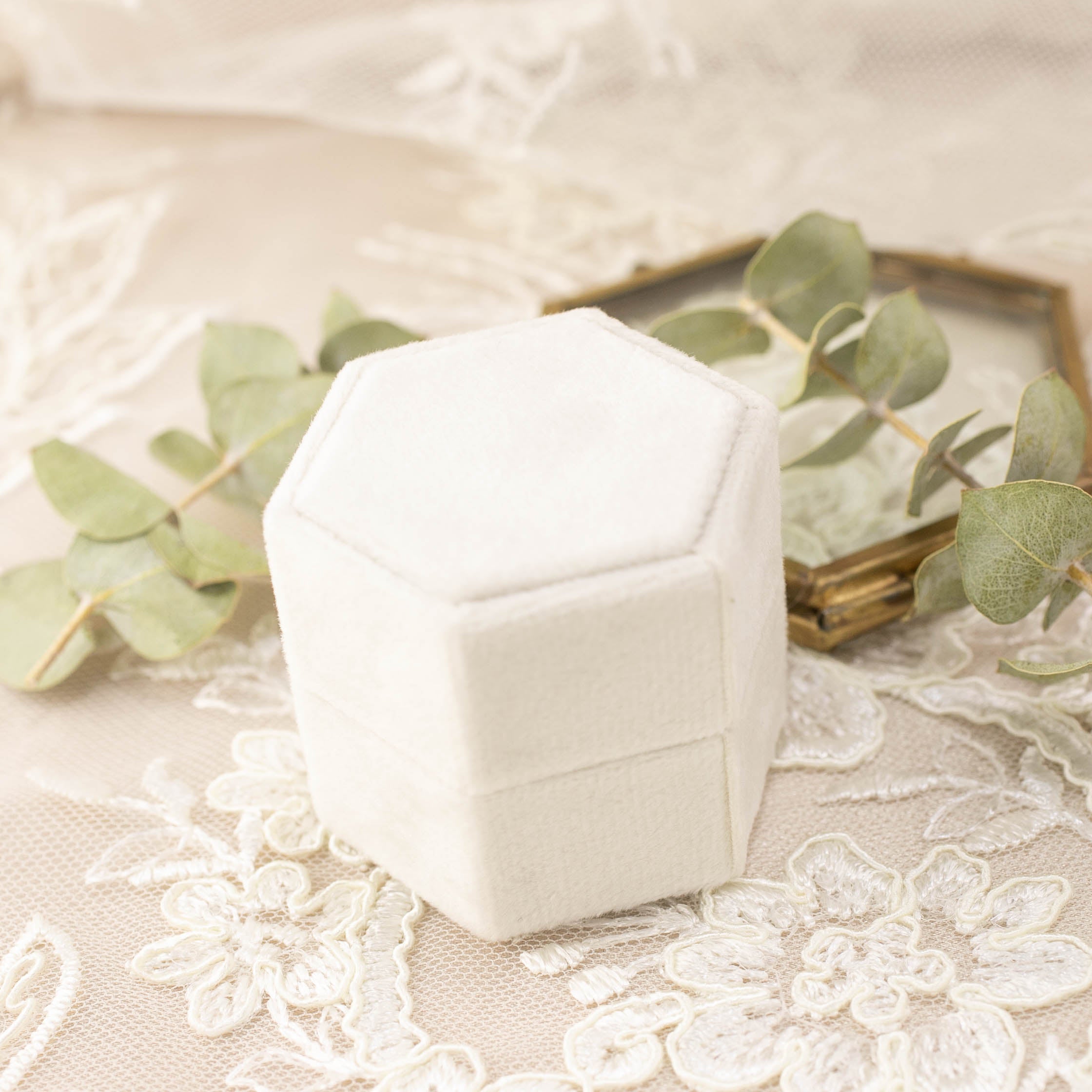 White velvet hexagonal ring box with grosgrain ribbon detail, perfect for engagement ring presentation and gifting.
