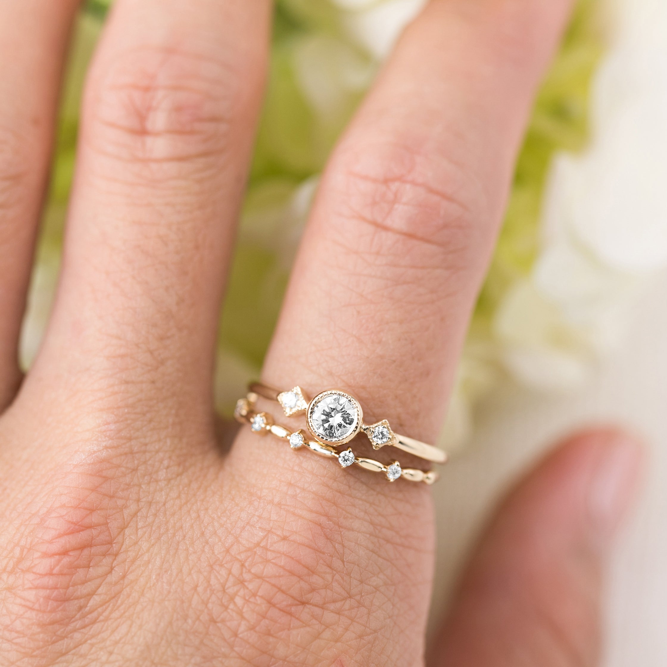 Hand wearing Distant Star Ring set with natural white diamonds on ethically sourced solid gold bands