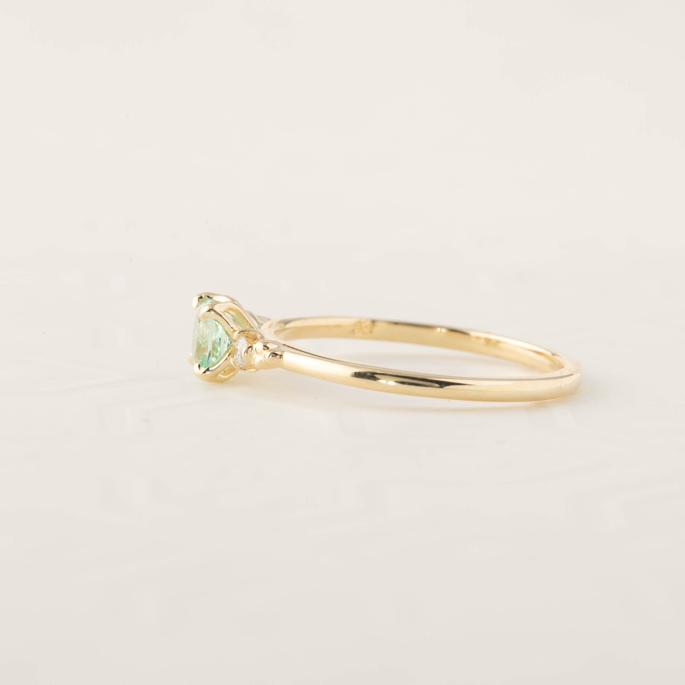 Delicate gold band ring with 4.5mm cushion cut natural mint tourmaline and small brilliant cut diamonds, size 7 adjustable.
