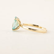 Side view of Sara Ring featuring 4ct blue zircon checkerboard cut set in 14k yellow gold band
