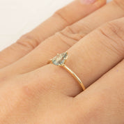 Delicate 14k yellow gold ring with 0.50ct unheated Madagascar sapphire in five-prong floral setting on finger