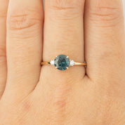 Three stone ring with 1.48ct green Montana sapphire and diamond accents set in recycled 14k gold band.