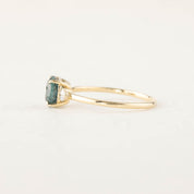 Three stone ring with 1.48ct green Montana sapphire and white diamond accents in 14k gold band.