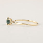 14k yellow gold ring with 1.12ct light blue green Montana sapphire in a classic high profile four-prong setting