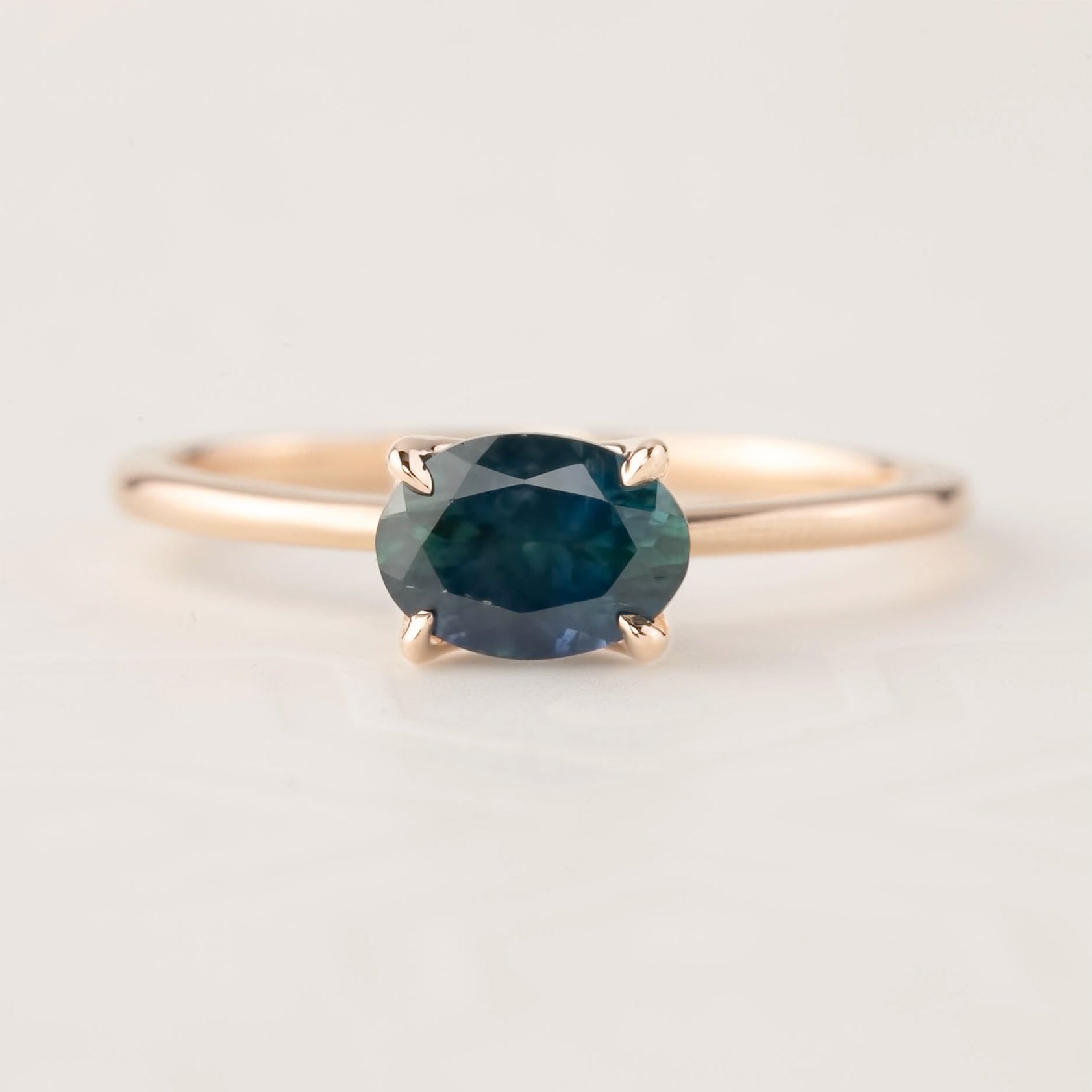 Sara Ring featuring 1.00ct green Montana sapphire set in 14k rose gold with a delicate tapered band and flower prong setting.