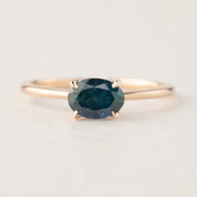 Sara Ring featuring 1.00ct green Montana sapphire set in 14k rose gold with a delicate tapered band and flower prong setting.