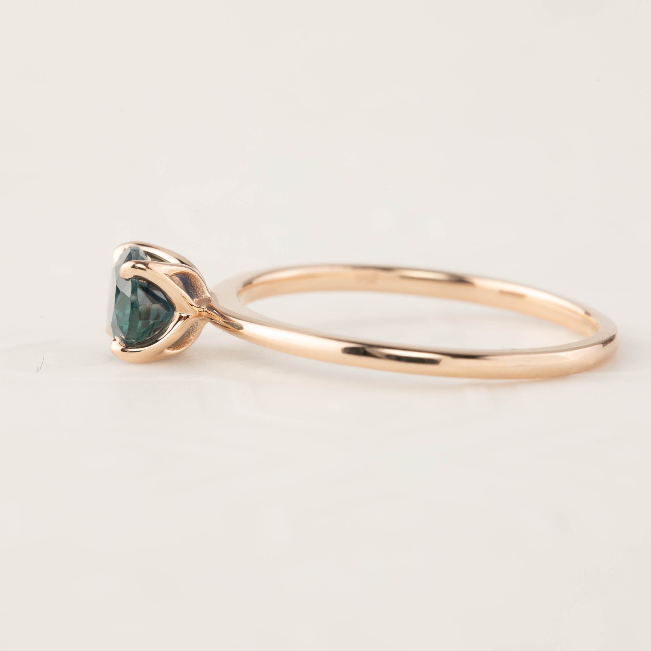 Sara Ring featuring 1.00ct green Montana Sapphire in a 14k rose gold tapered band with a 4-prong flower setting