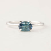 Sara Ring with 1.00ct blue-green Montana Sapphire in 14k white gold, classic four-prong setting, tapered band.