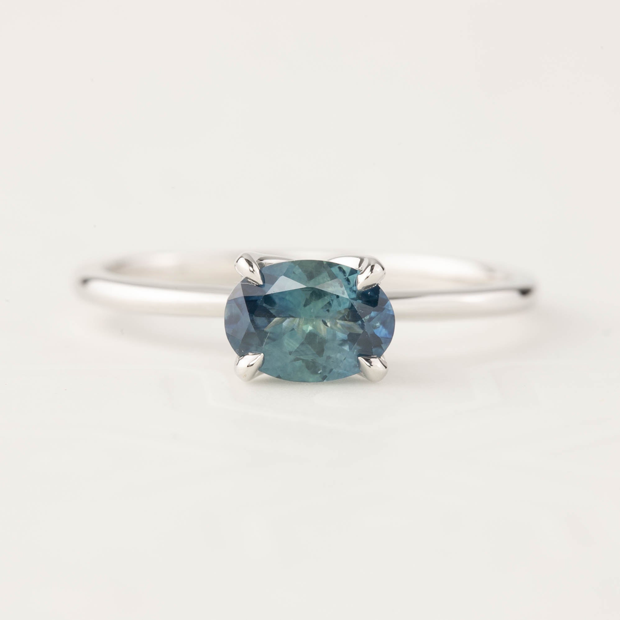 Sara Ring with 1.00ct blue-green Montana Sapphire in 14k white gold, classic four-prong setting, tapered band.
