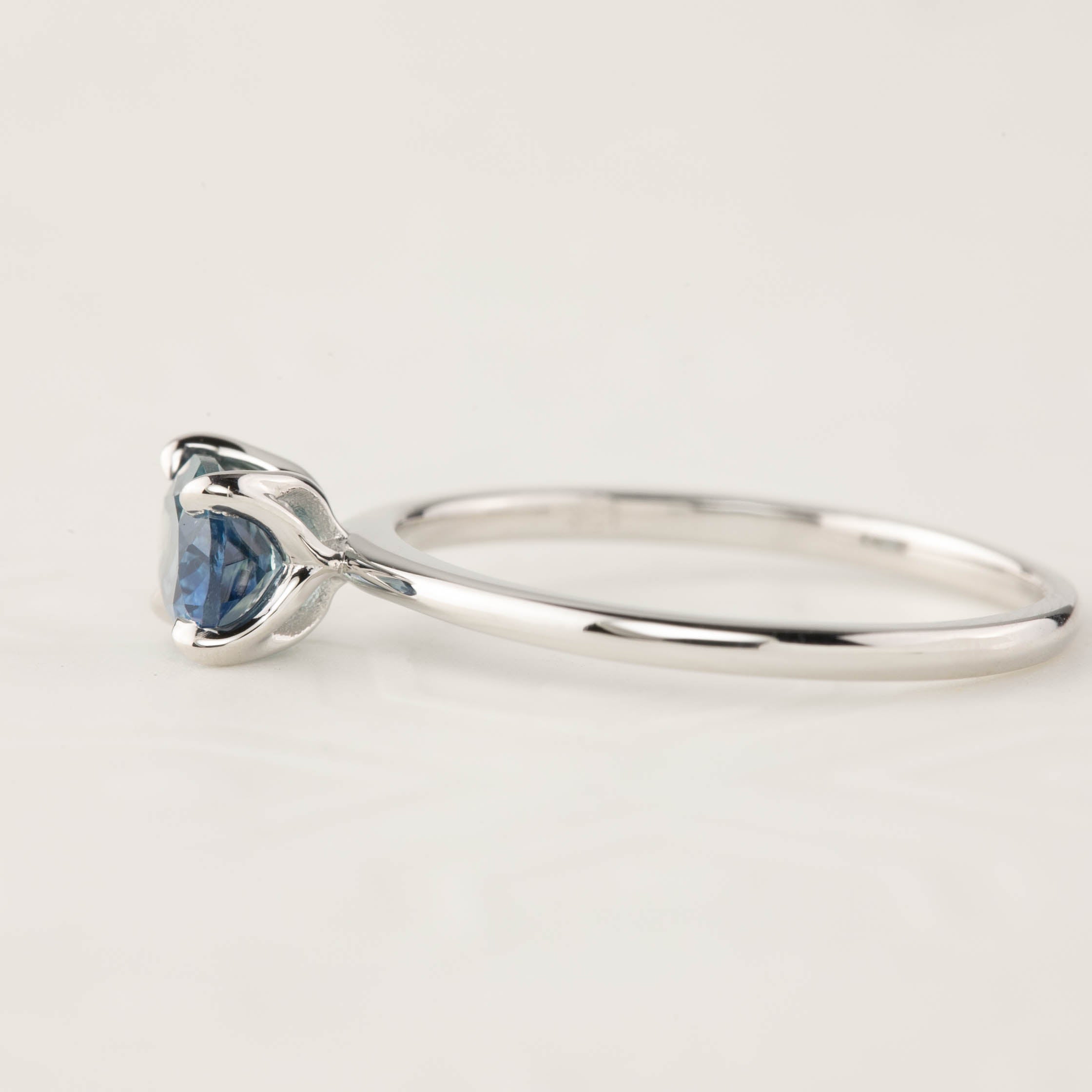 Sara Ring with 1.00ct blue green Montana sapphire in 14k white gold, classic 4 prong setting, delicate tapered band