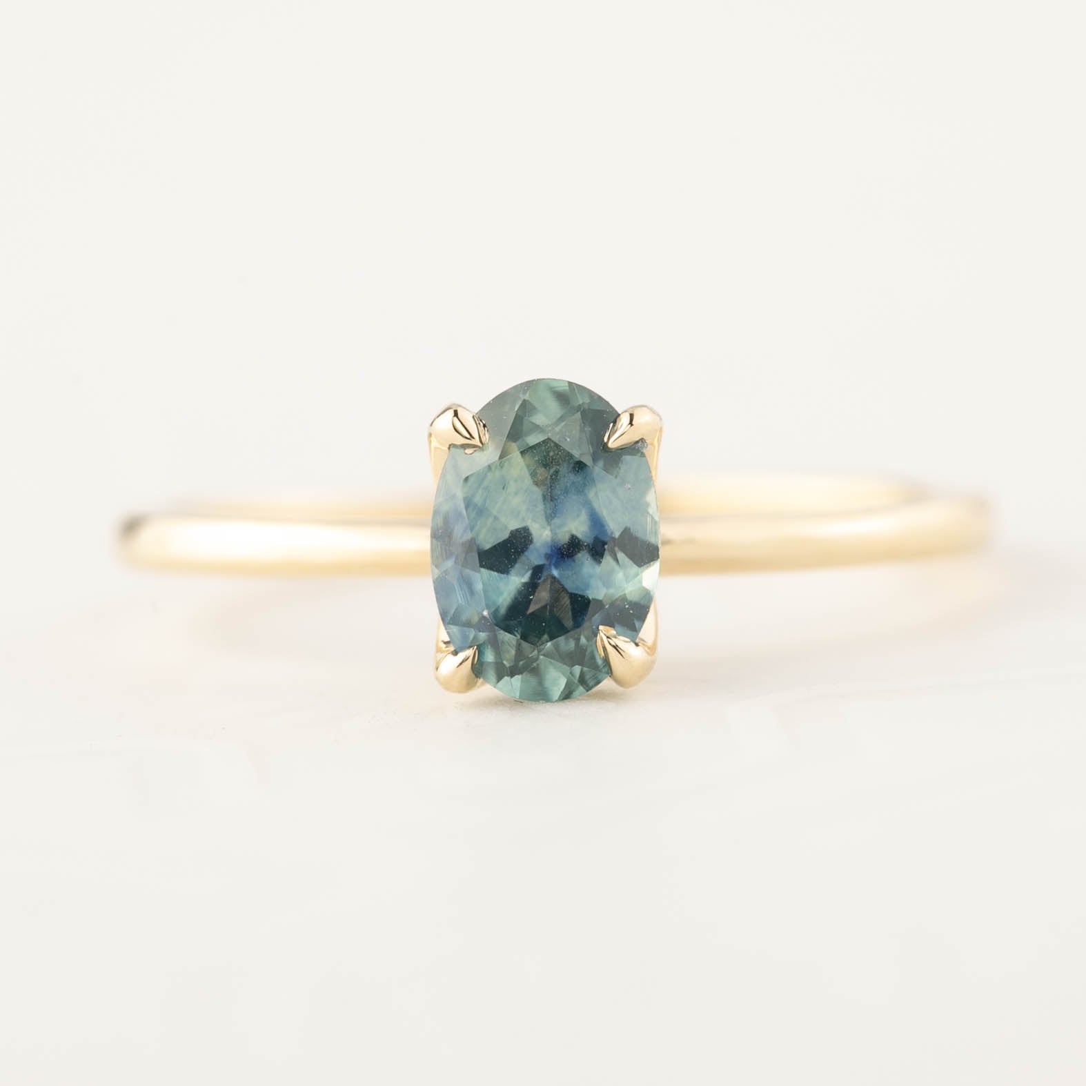 Sara Ring with 1.00ct parti blue green Montana sapphire set in 14k recycled yellow gold with a delicate band